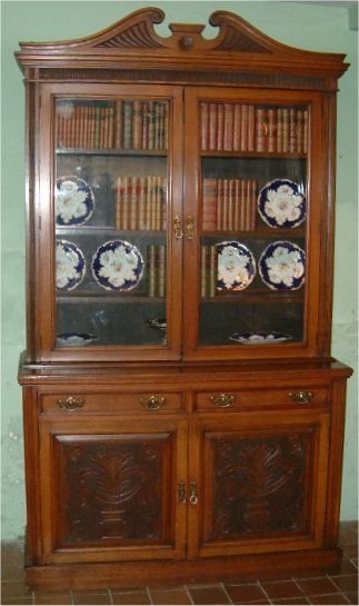 edwardian oak bookcase with carved panels swan neck pediment