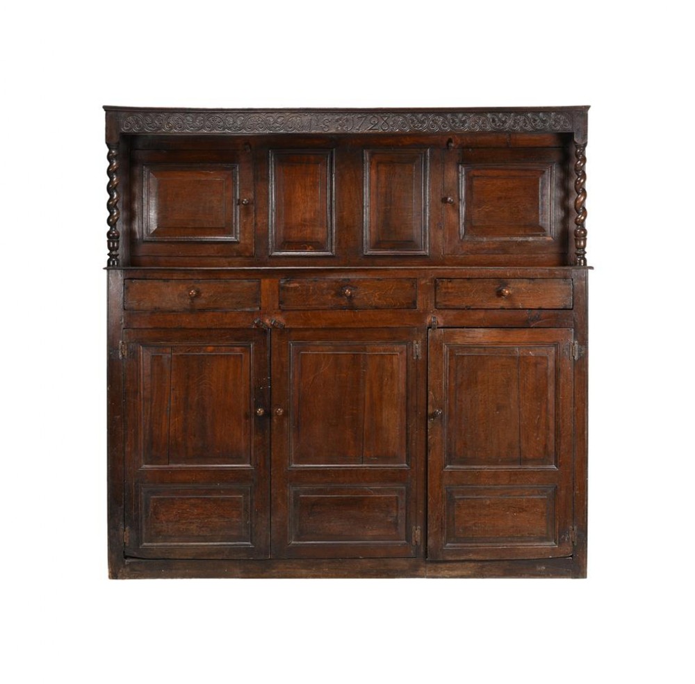18thc oak court cupboard bearing date 1728 to carved frieze