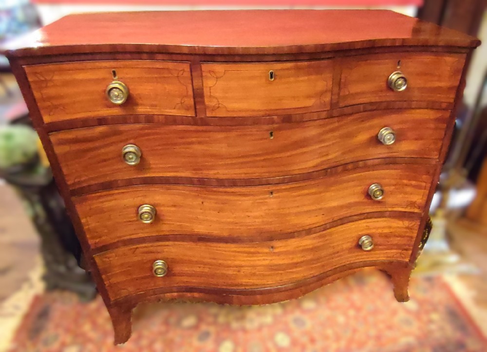 regency period serpentine mahogany chest