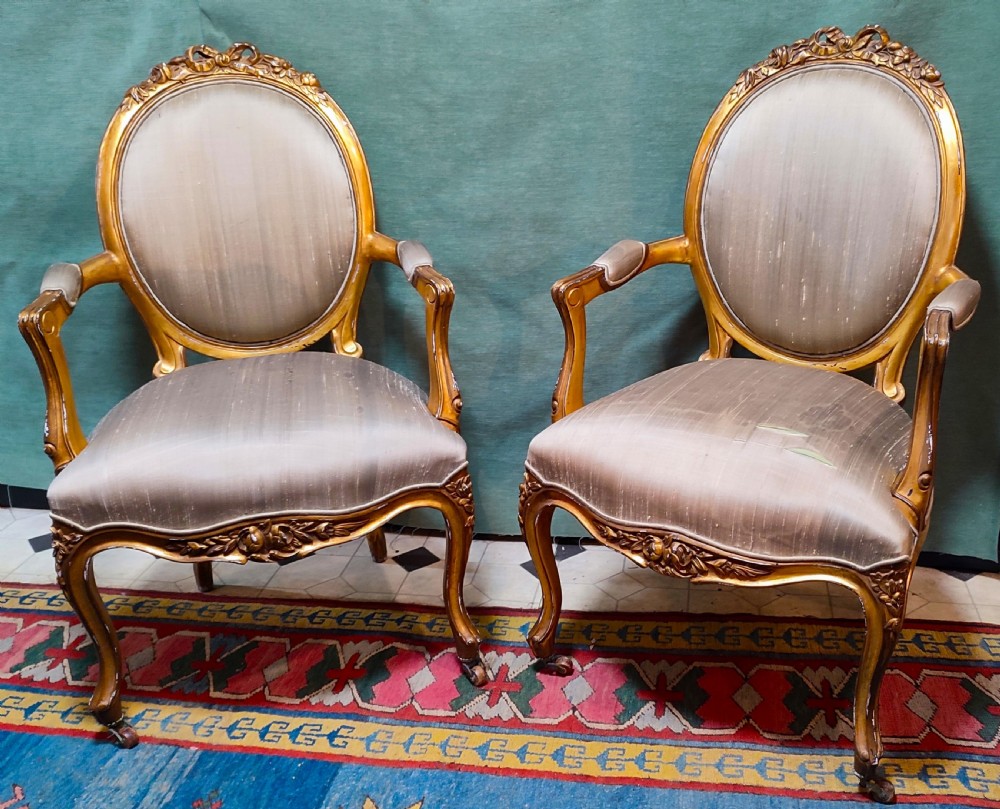 pair of 19thc giltwood armchairs with silk fabric